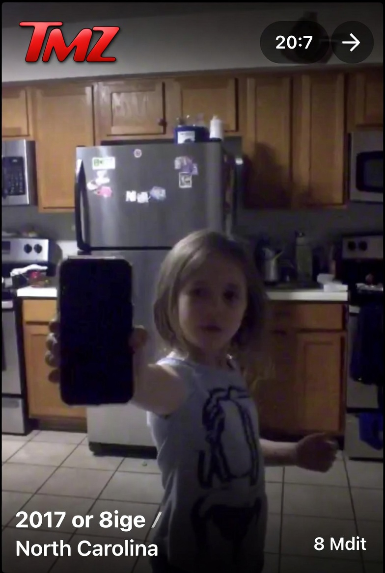 Girl Showing a Phone in a Grainy Kitchen Video