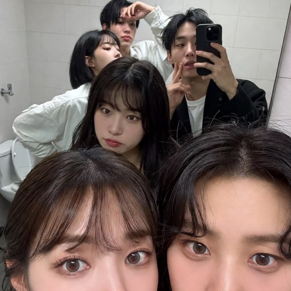Casual K-Pop Group Mirror Selfie in a Bathroom