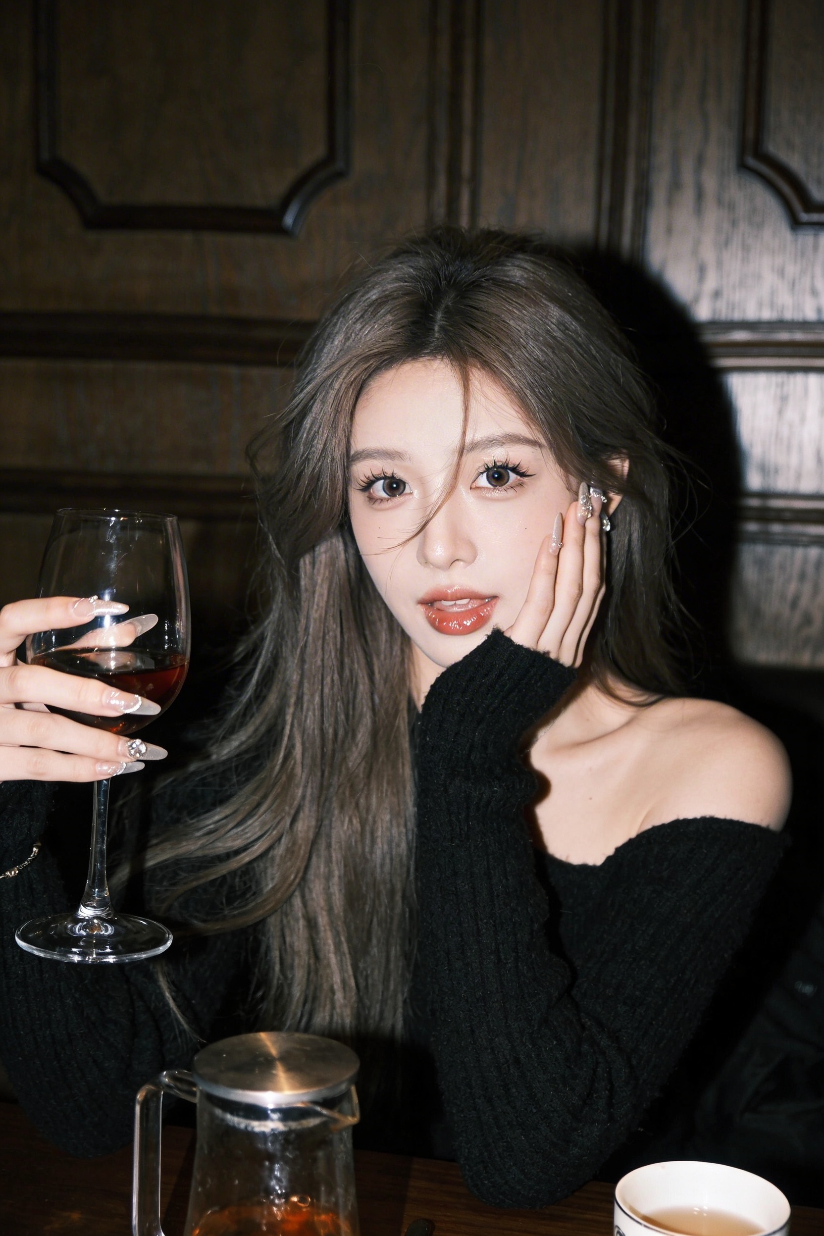 Playful Wine Portrait at a Dark Dining Table