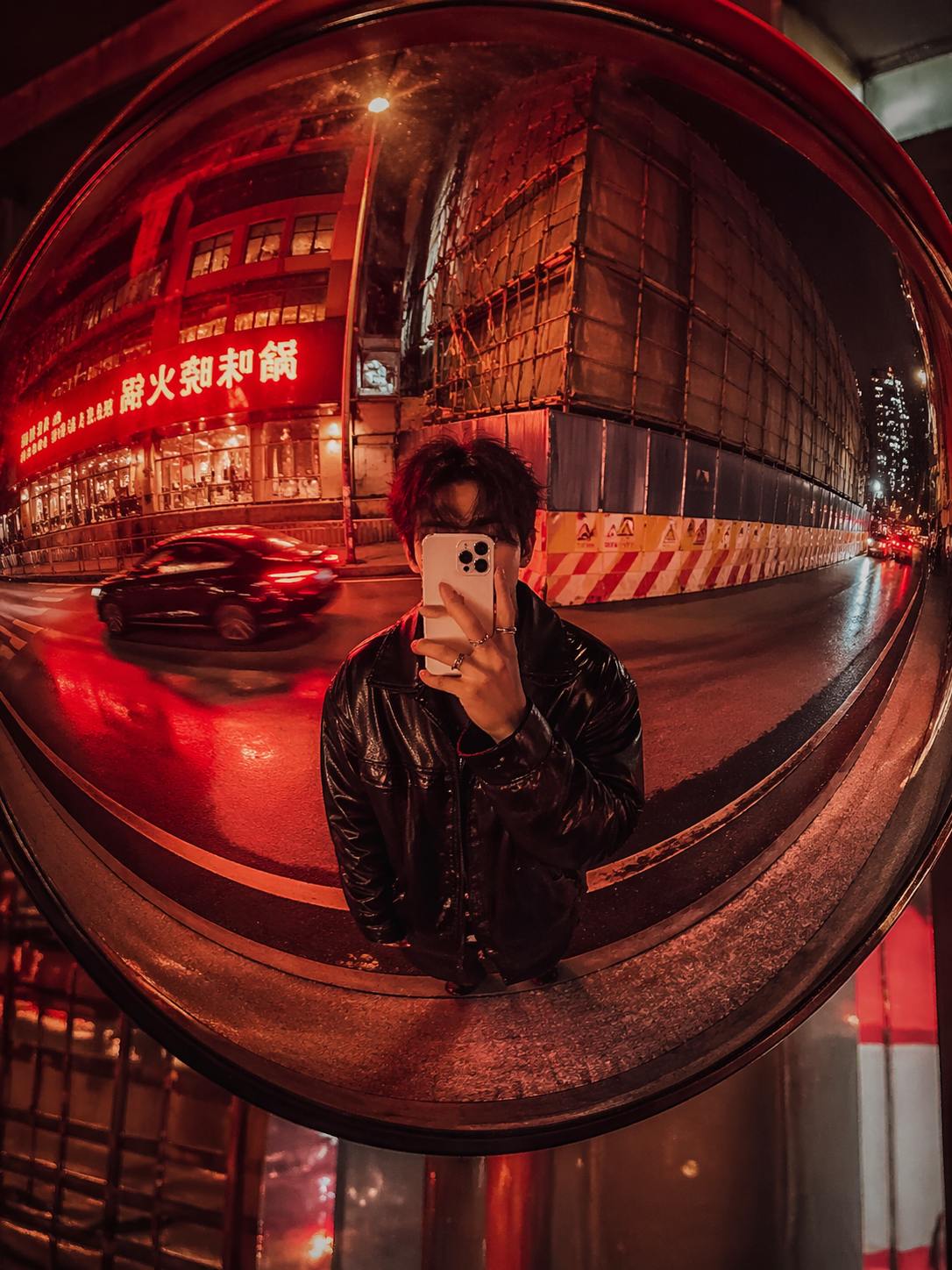 红色霓虹凸面街镜中的 iPhone 人像