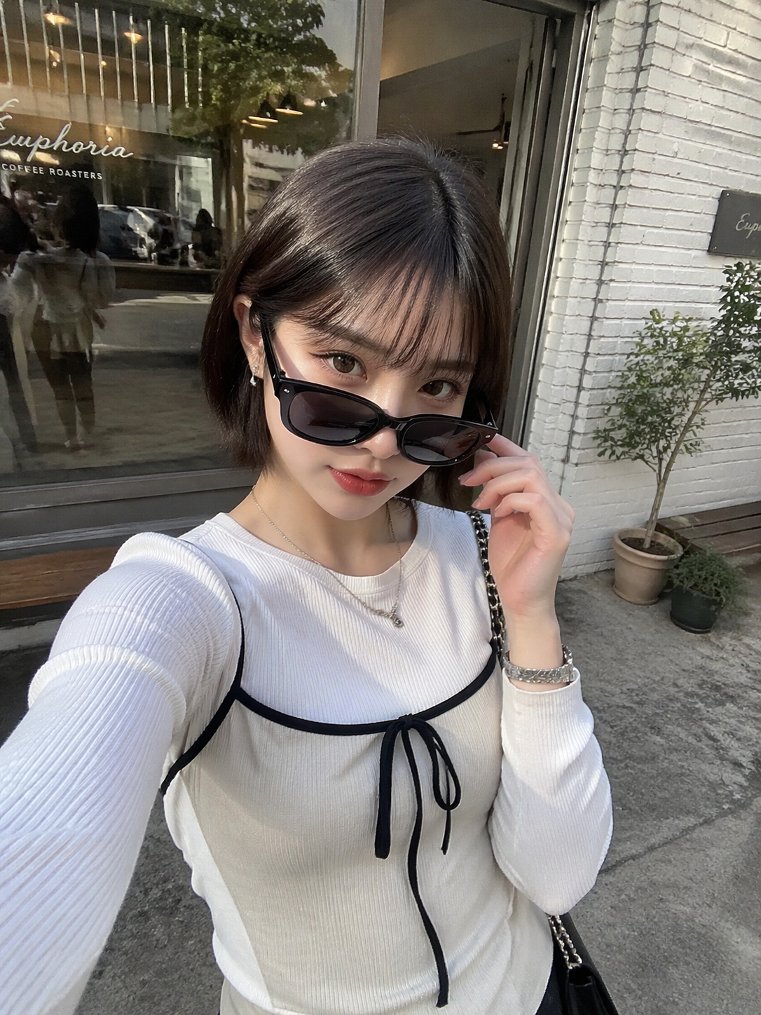 Selfie d’une Japonaise en mode coréenne devant un café