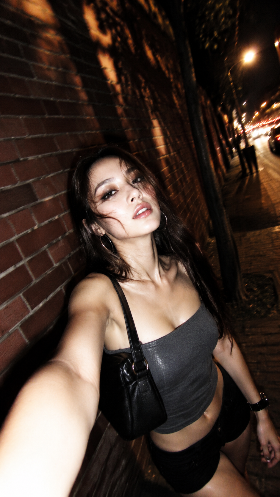 Low-Angle Flash Selfie on a Warm Night Street