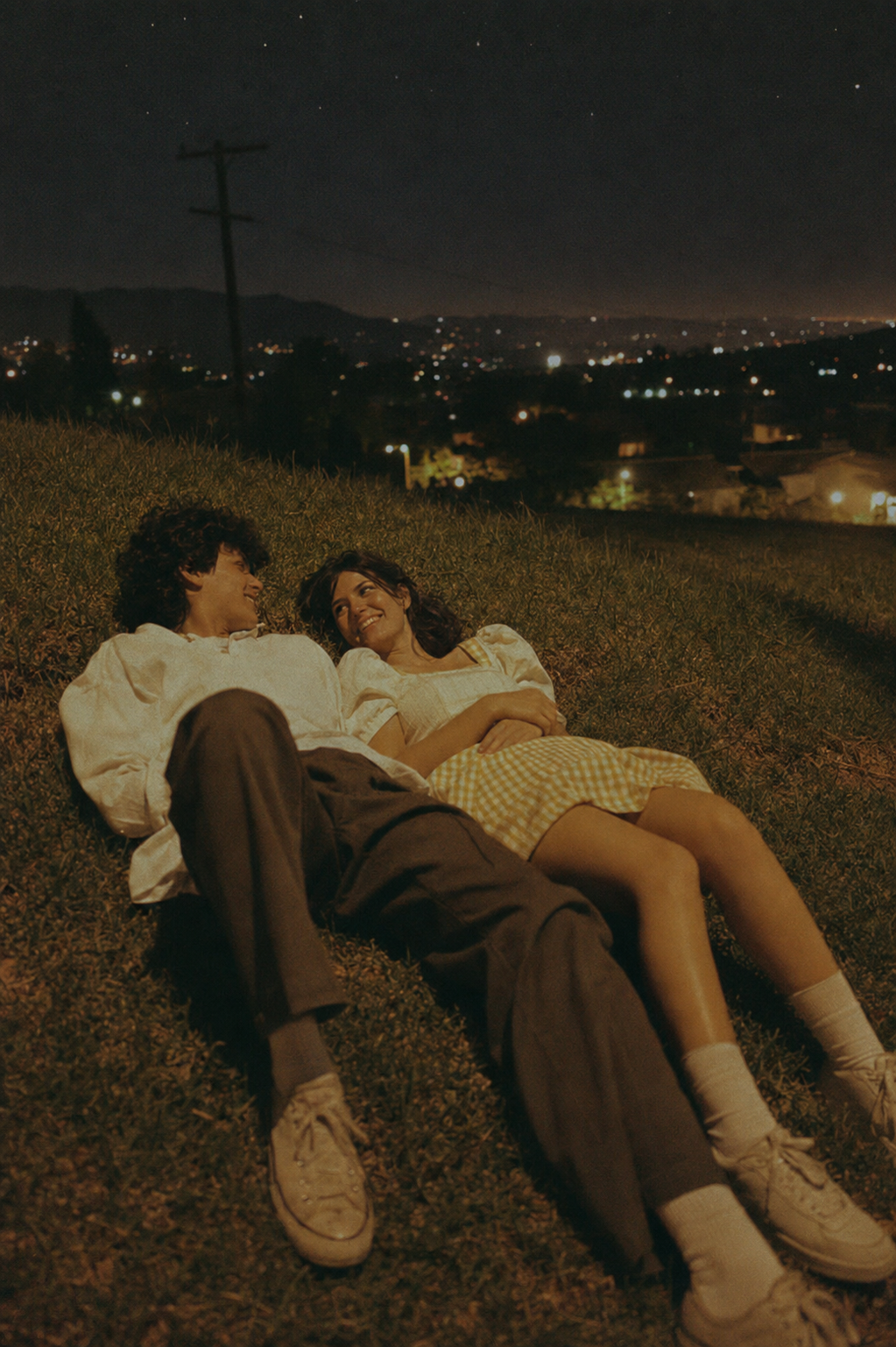 Young Couple Laughing on a Moonlit Hill